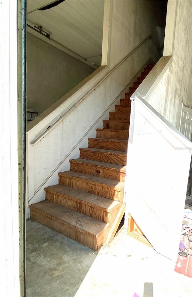 staircase with concrete flooring