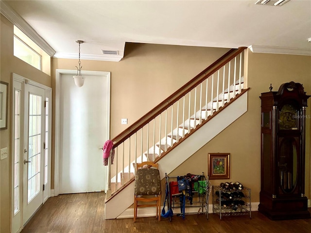 entryway with french doors, crown molding, and wood-type flooring