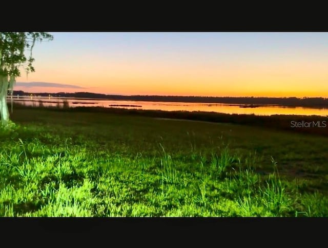 nature at dusk featuring a water view