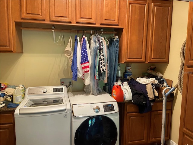 washroom with cabinets and washer and dryer