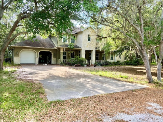 view of front of home featuring a garage and a porch