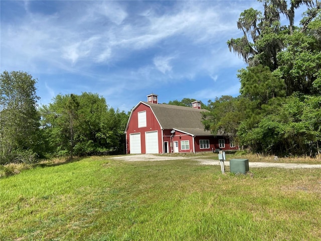 view of outbuilding featuring a garage and a yard