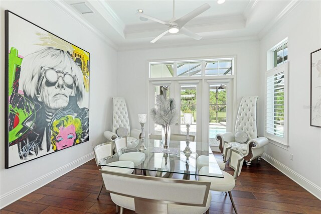 dining room with ceiling fan, dark hardwood / wood-style floors, crown molding, and a raised ceiling