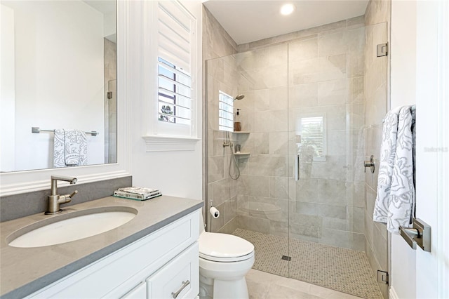 bathroom featuring tile patterned flooring, vanity, walk in shower, and toilet