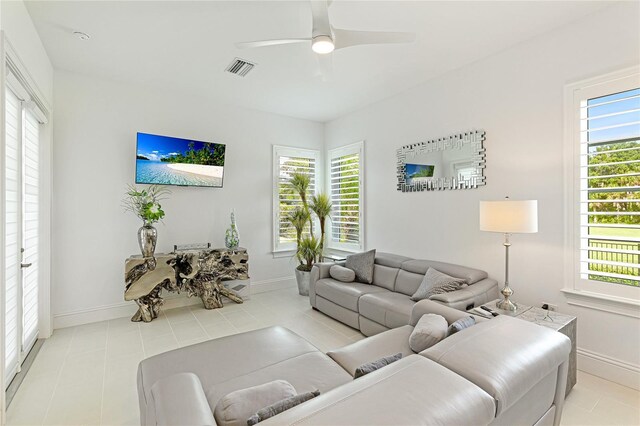 living room featuring light tile patterned floors, plenty of natural light, and ceiling fan