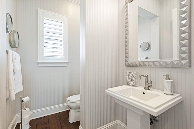 bathroom with wood-type flooring and toilet