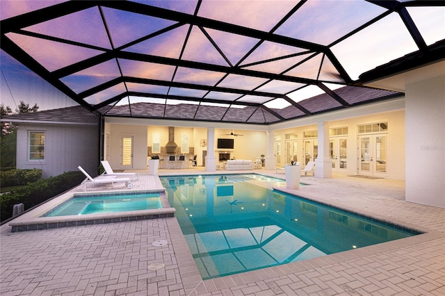 view of pool featuring ceiling fan, a lanai, an in ground hot tub, and a patio