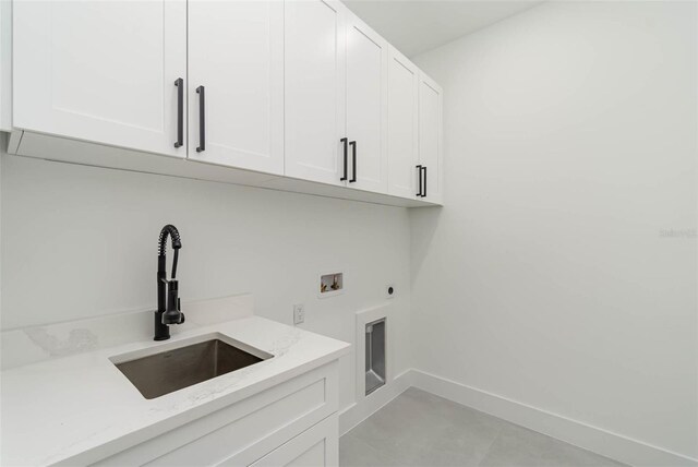 laundry area featuring cabinets, light tile patterned flooring, electric dryer hookup, sink, and washer hookup