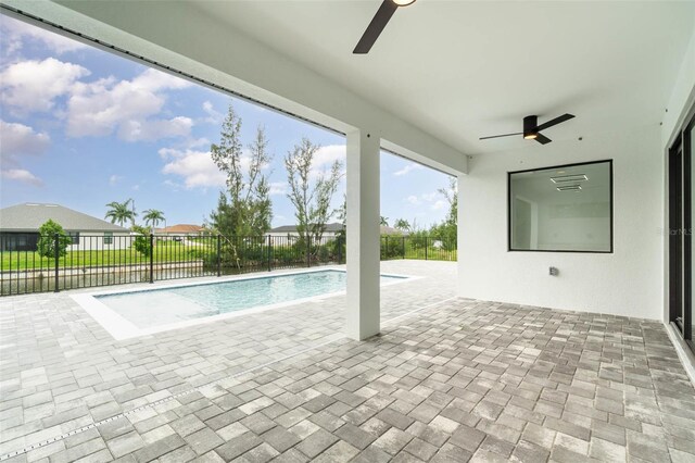 view of pool with a patio area and ceiling fan