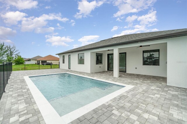 view of pool with ceiling fan and a patio