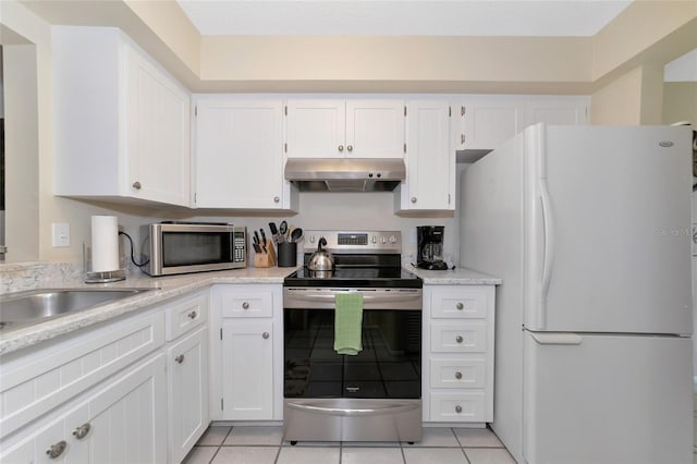 kitchen with white cabinetry, appliances with stainless steel finishes, and light tile patterned floors