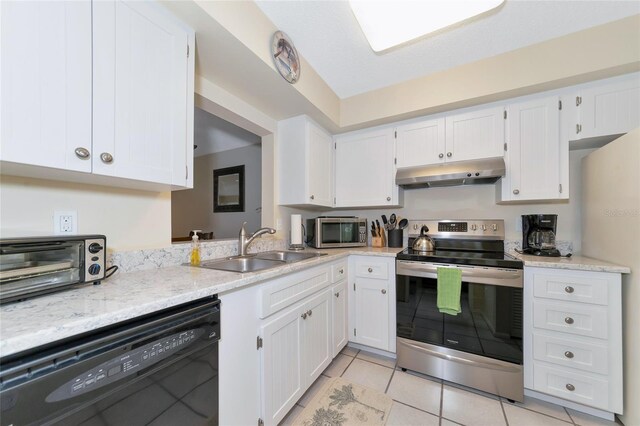 kitchen featuring light tile patterned flooring, appliances with stainless steel finishes, sink, and white cabinets