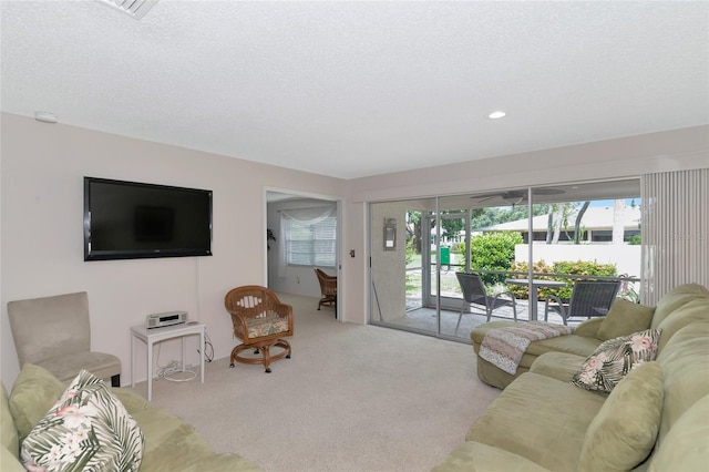 living room with light colored carpet and a textured ceiling