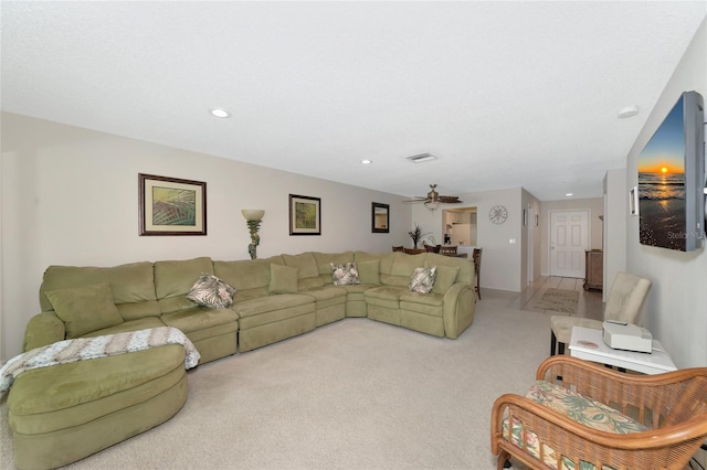 carpeted living room featuring ceiling fan