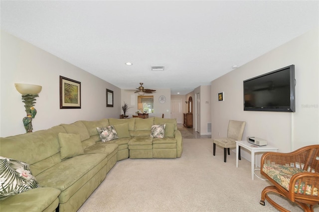 carpeted living room with ceiling fan