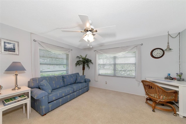 carpeted living room with ceiling fan and a textured ceiling