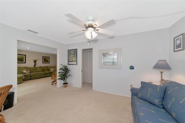 carpeted living room featuring ceiling fan