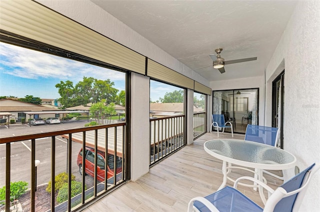 sunroom / solarium featuring ceiling fan