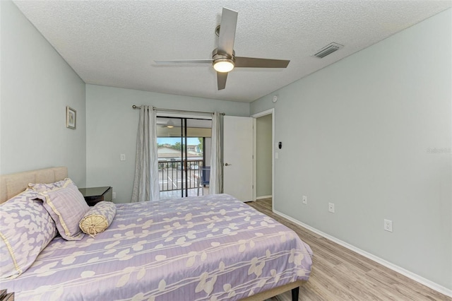 bedroom with access to outside, a textured ceiling, ceiling fan, and light hardwood / wood-style floors