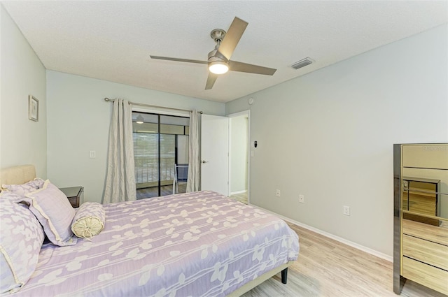 bedroom featuring a textured ceiling, wood-type flooring, and ceiling fan