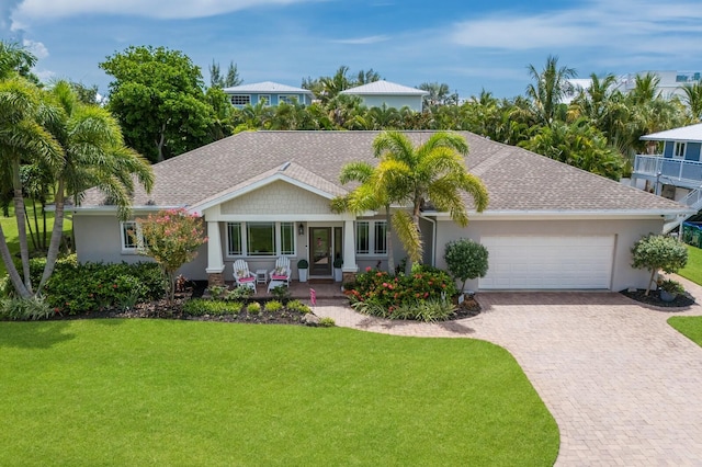 view of front of home featuring a garage and a front yard