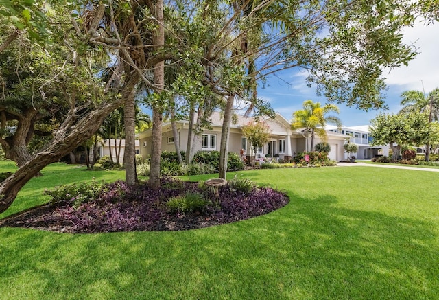 view of front of house featuring a garage and a front yard