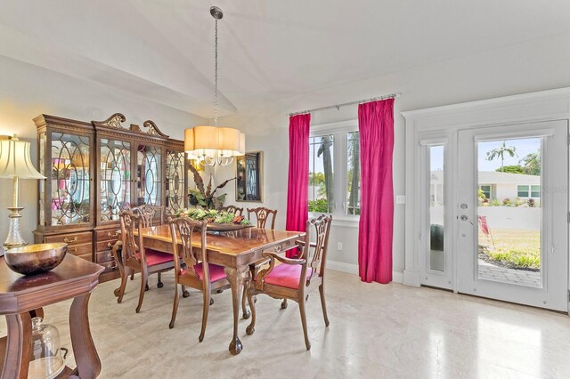 dining area with a notable chandelier and light tile patterned flooring