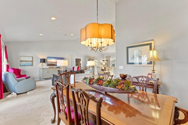 dining area featuring vaulted ceiling, tile patterned flooring, and a notable chandelier