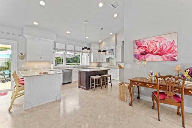 kitchen with white cabinetry, plenty of natural light, stainless steel dishwasher, and a kitchen island