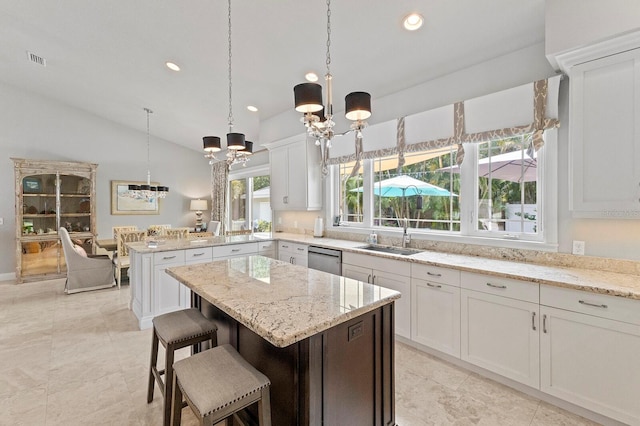 kitchen with sink, light tile patterned floors, white cabinetry, a chandelier, and dishwasher