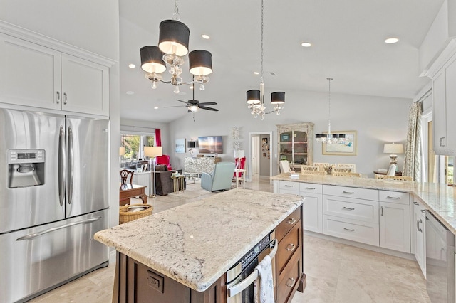 kitchen featuring stainless steel appliances, white cabinets, ceiling fan with notable chandelier, lofted ceiling, and light tile patterned flooring