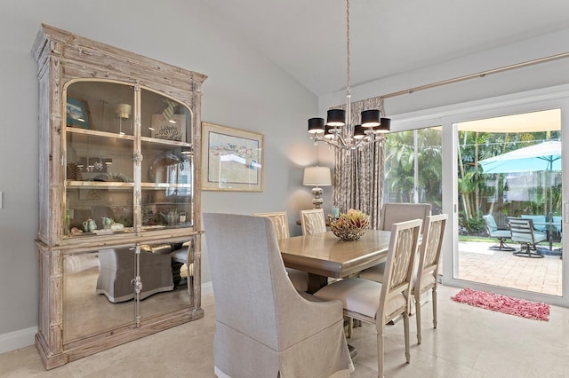 dining area with lofted ceiling and a chandelier