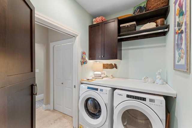 laundry room with cabinets and washing machine and clothes dryer