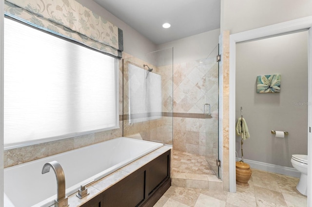 bathroom featuring tile patterned flooring, toilet, and separate shower and tub