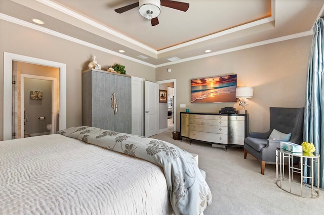 bedroom with ceiling fan, light colored carpet, crown molding, and a tray ceiling