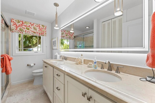 bathroom featuring double vanity, tile patterned flooring, and toilet