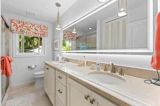 bathroom with walk in shower, vanity, and toilet