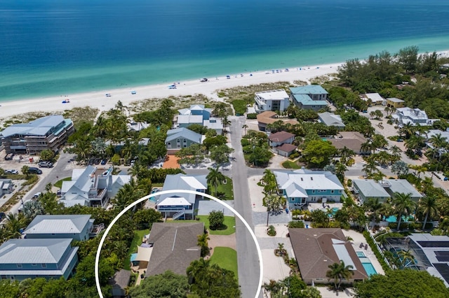 drone / aerial view featuring a view of the beach and a water view