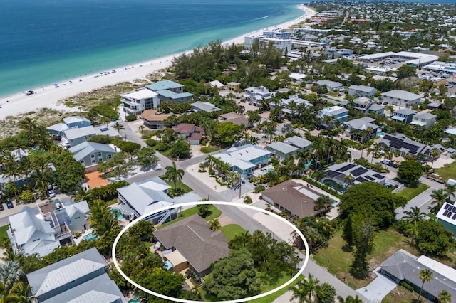 drone / aerial view with a water view and a beach view