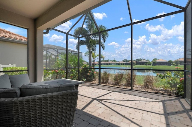 sunroom / solarium featuring a water view