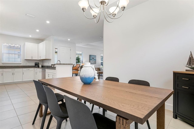 tiled dining area featuring a chandelier