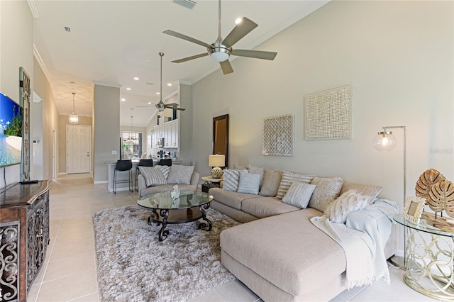 living area with light tile patterned floors, high vaulted ceiling, recessed lighting, visible vents, and a ceiling fan