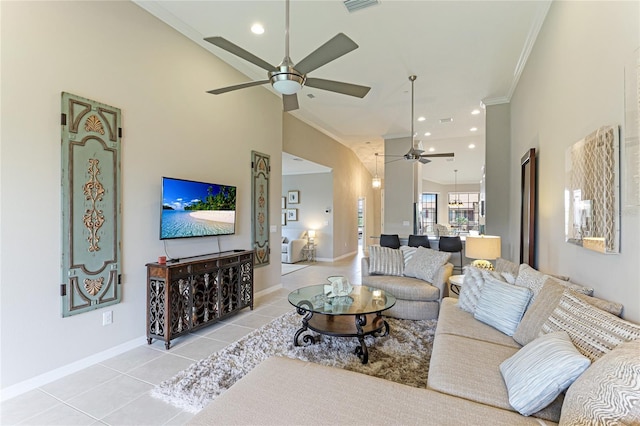 tiled living room featuring ornamental molding, ceiling fan, and a high ceiling