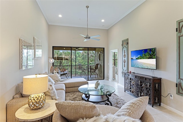 living room featuring ceiling fan, light tile patterned floors, a wealth of natural light, and a towering ceiling