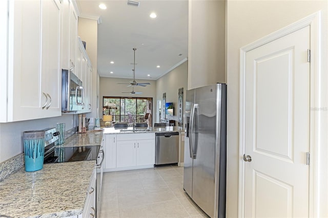 kitchen with stainless steel appliances, ceiling fan, light tile patterned flooring, white cabinetry, and light stone counters