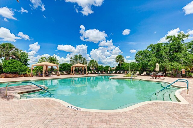 view of swimming pool with a patio area and a gazebo