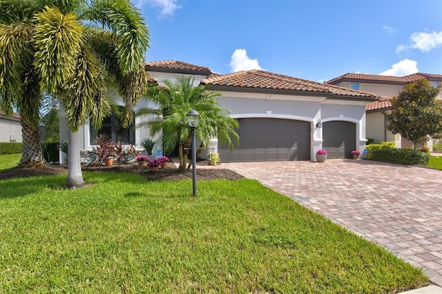 mediterranean / spanish house with a front yard and a garage