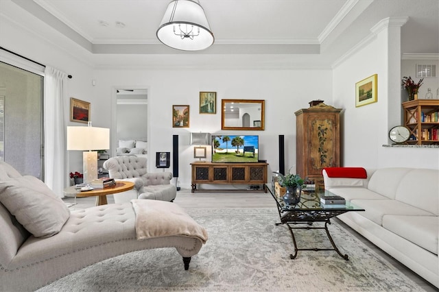 living room featuring crown molding and light wood-type flooring