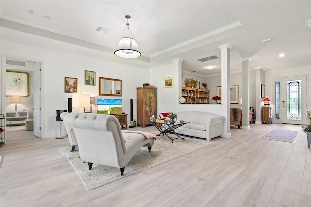 living room featuring ornamental molding, light hardwood / wood-style floors, and ornate columns