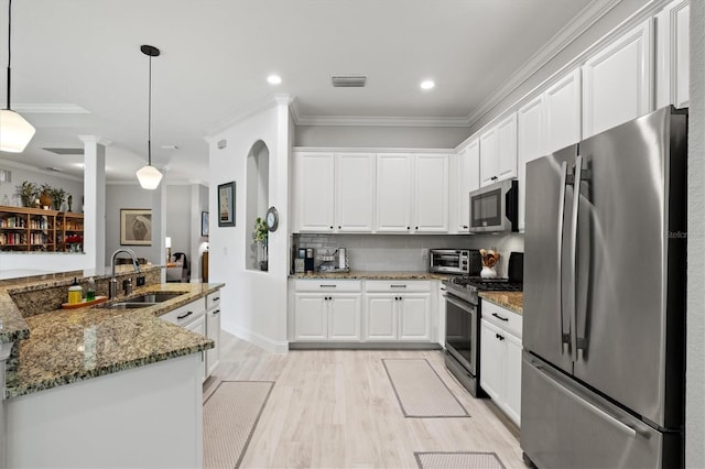 kitchen featuring sink, appliances with stainless steel finishes, and white cabinetry